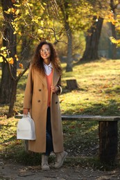 Photo of Full length portraitbeautiful African-American woman with stylish white backpack in autumn park