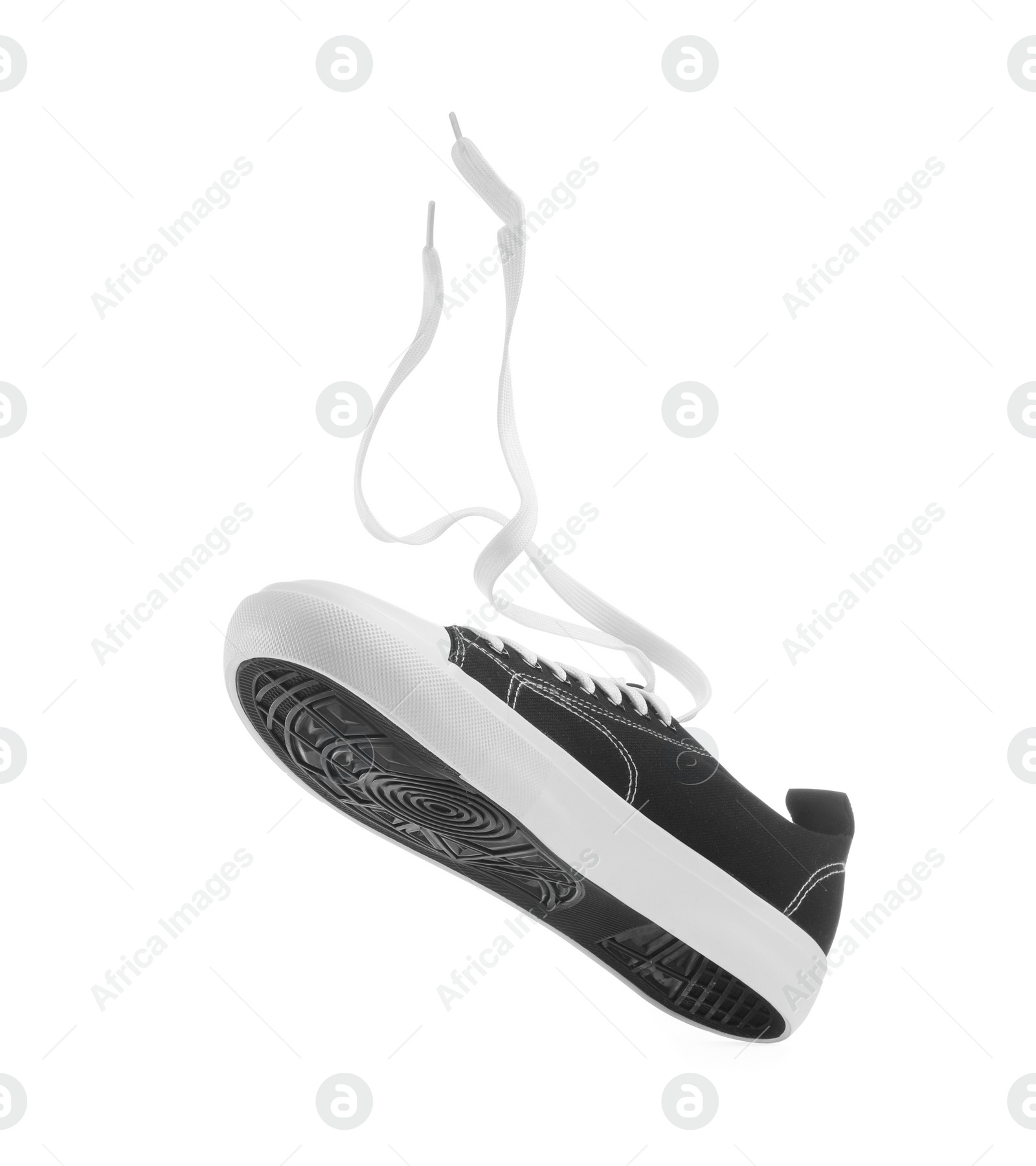 Photo of One black classic old school sneaker isolated on white