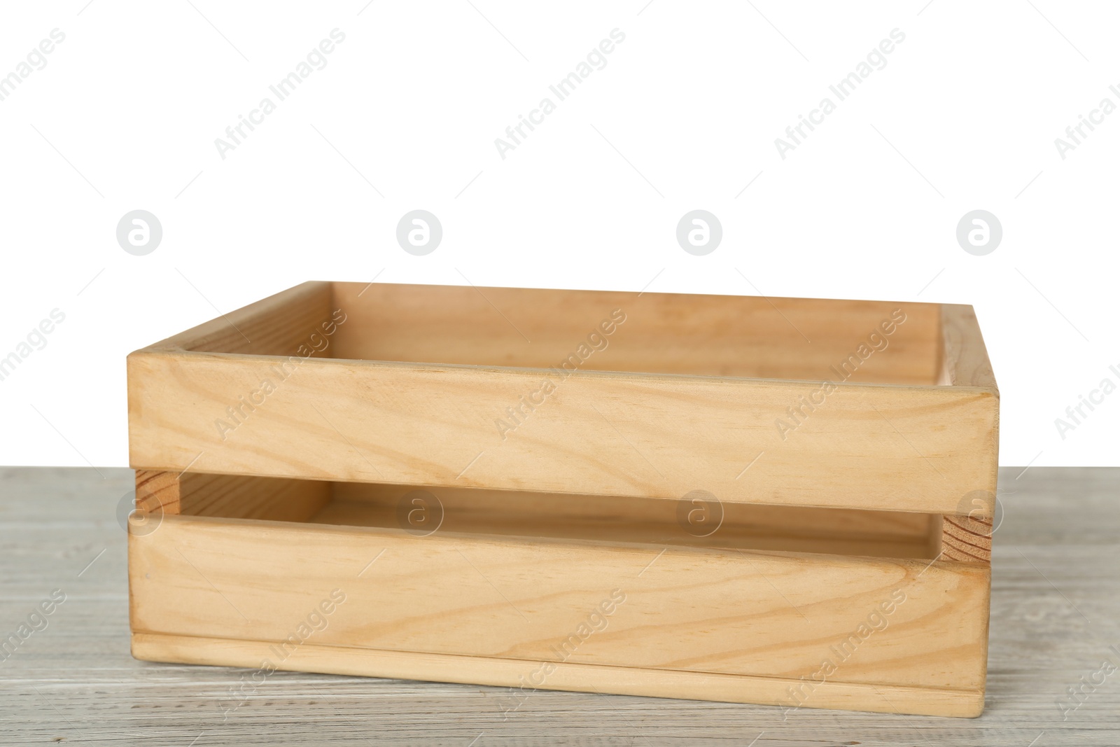 Photo of Empty rustic wooden crate on table against white background