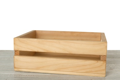 Photo of Empty rustic wooden crate on table against white background