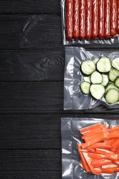 Photo of Tasty food in vacuum packings on black wooden table, flat lay. Space for text