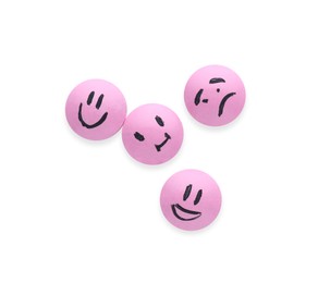 Pink antidepressant pills with emotional faces isolated on white, top view