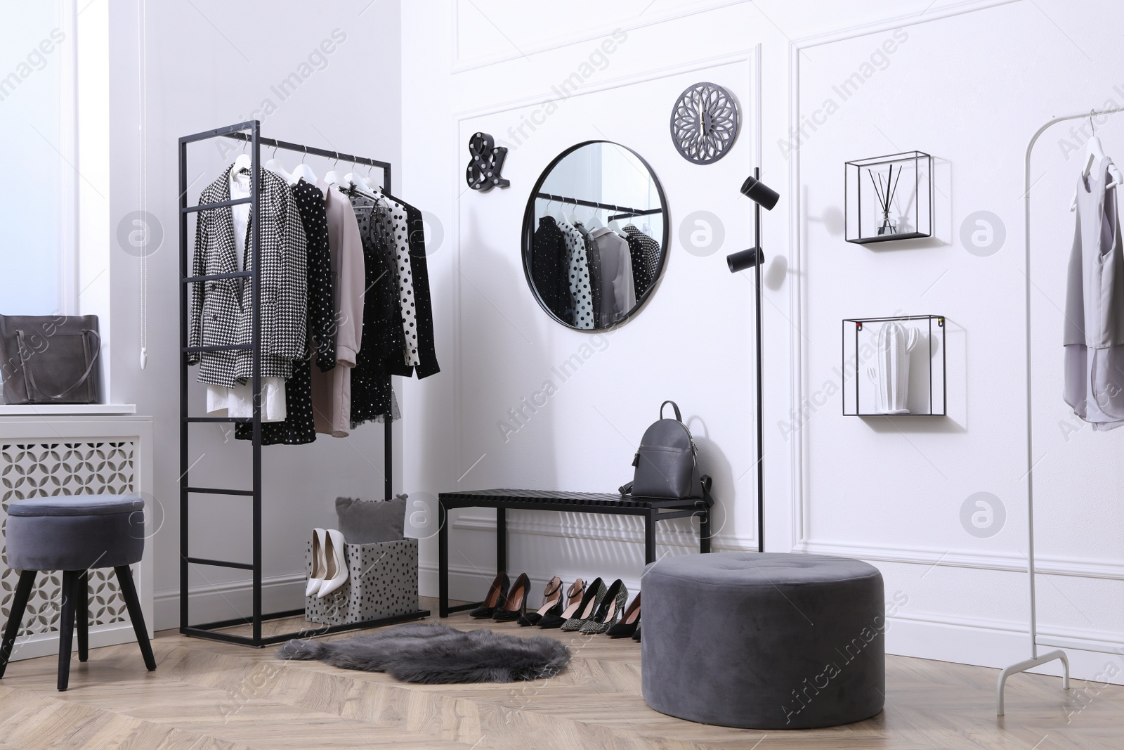 Photo of Dressing room with stylish clothes, shoes and accessories. Elegant interior design