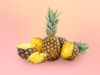 Image of Cut and whole pineapples on color gradient background