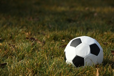 Photo of Soccer ball on green grass outdoors, space for text