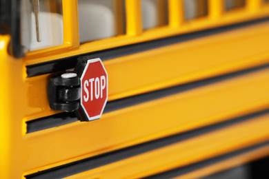 Photo of Yellow school bus, focus on stop sign. Transport for students