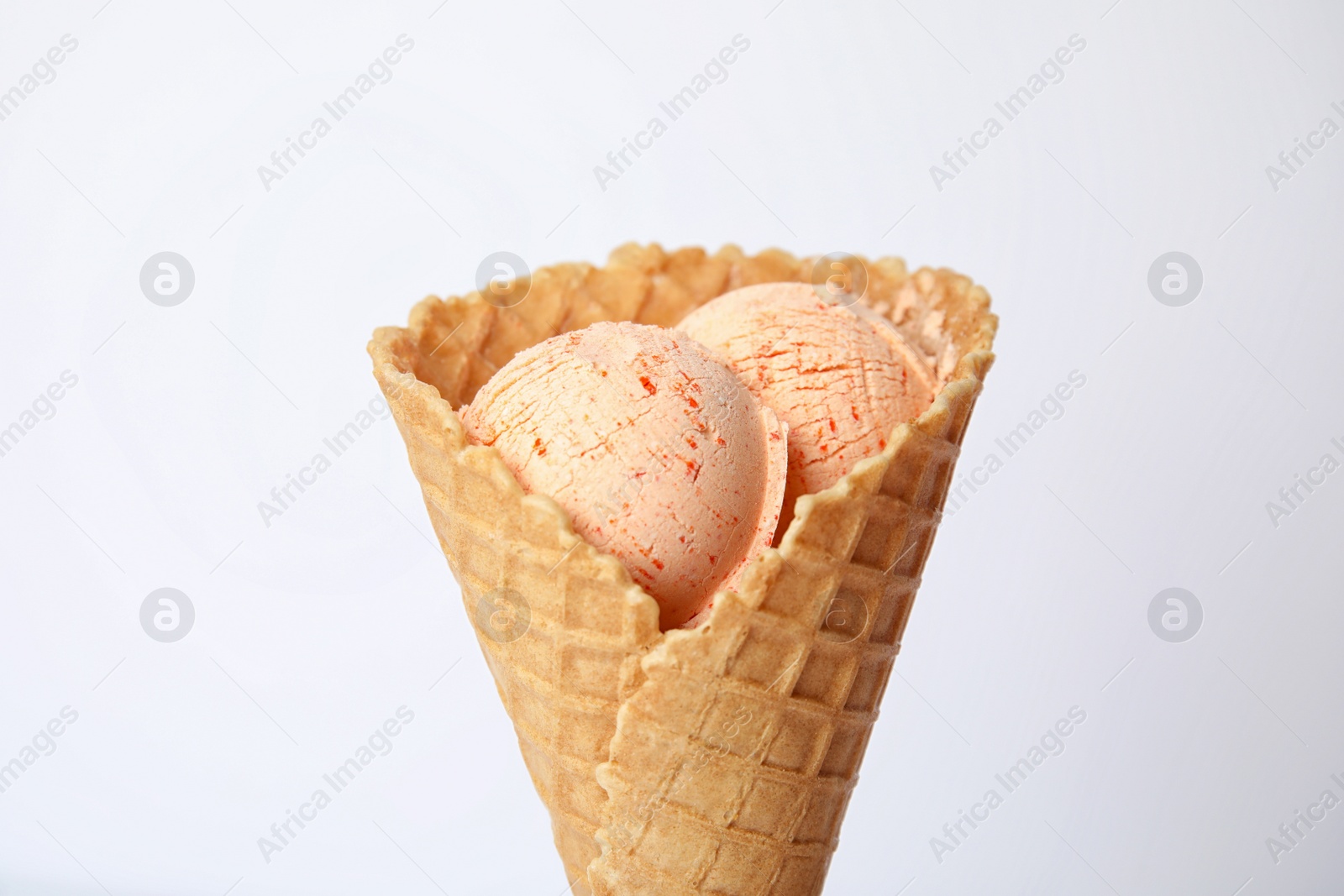 Photo of Delicious ice cream in waffle cone on white background