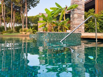 Photo of Swimming pool and exotic plants at luxury resort