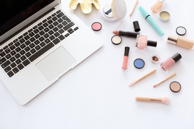 Photo of Flat lay composition with makeup products for woman and laptop on white background