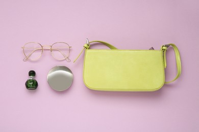 Flat lay composition with stylish baguette handbag on lilac background