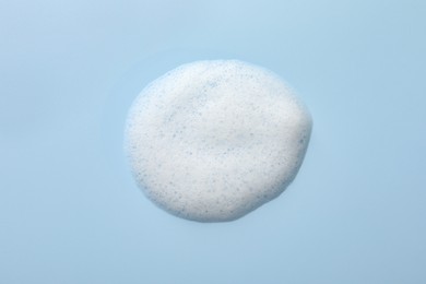 Photo of Foam sample on light blue background, top view