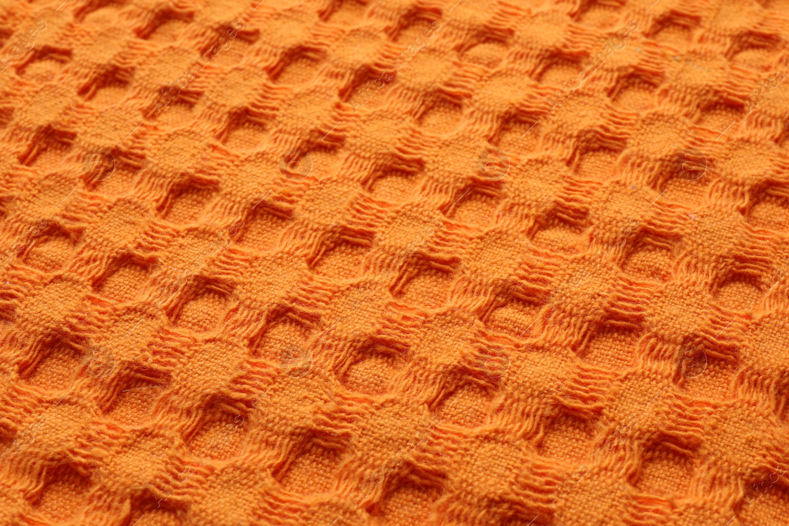 Photo of Texture of orange knitted fabric as background, closeup