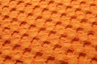 Photo of Texture of orange knitted fabric as background, closeup