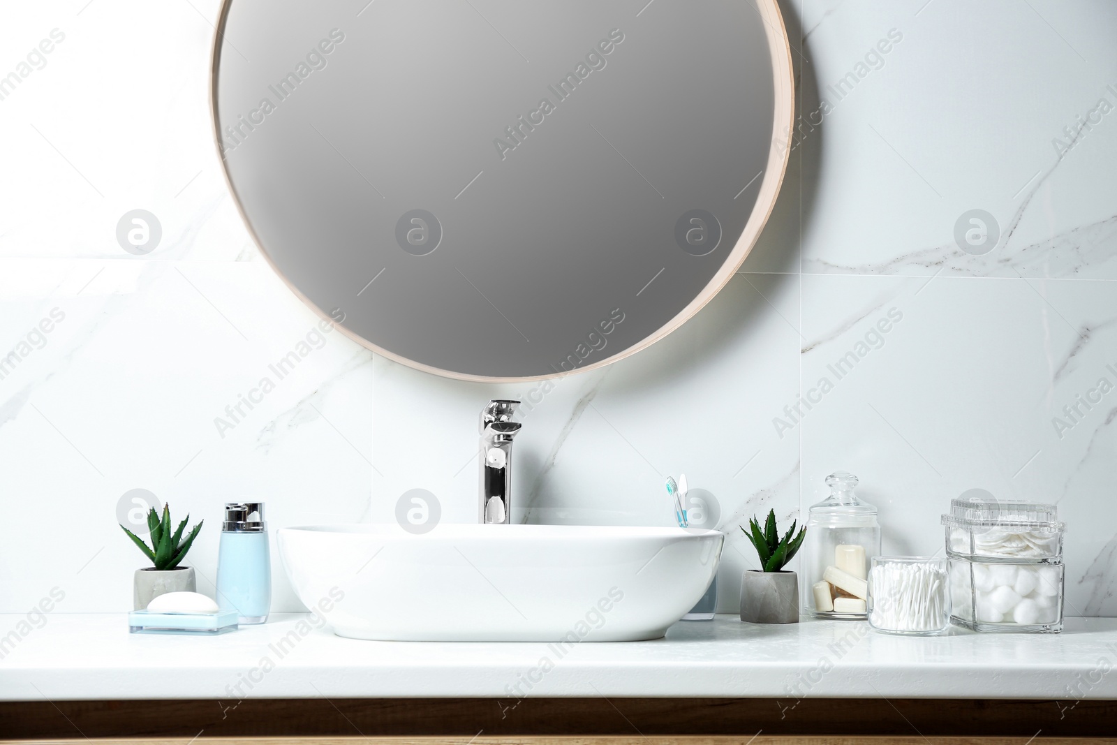 Photo of Cotton swabs and other hygiene products on countertop in bathroom