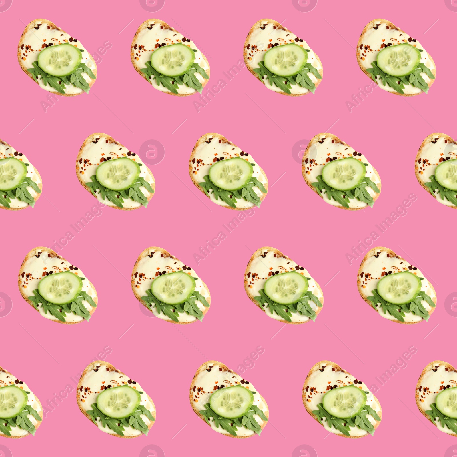 Image of Set of delicious toasted bread with spread, cucumber and arugula on pink background, top view