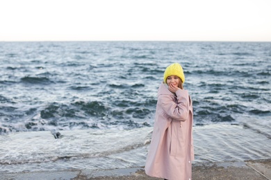 Photo of Portrait of beautiful young woman near sea