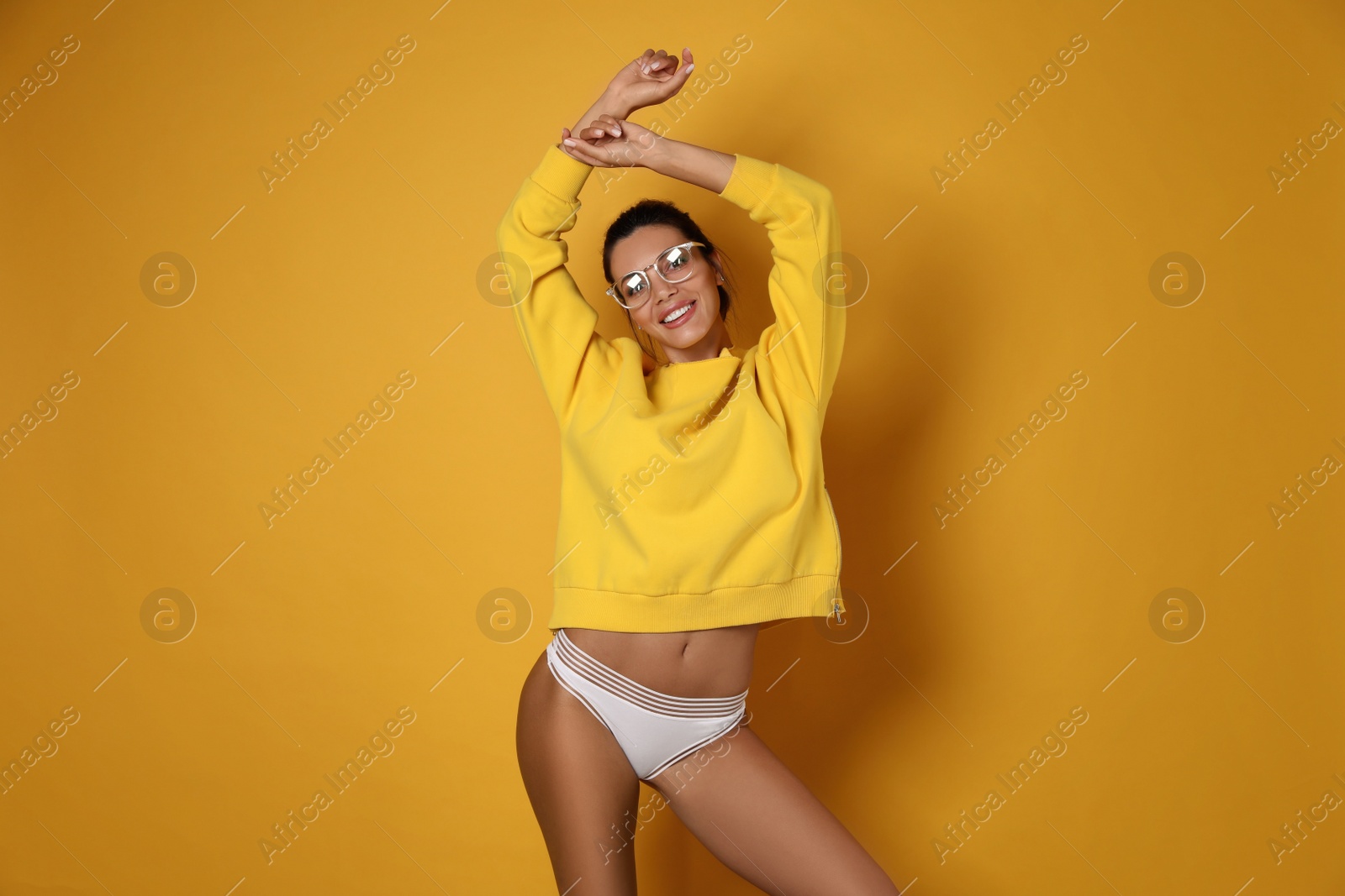 Photo of Beautiful woman in white panties on yellow background