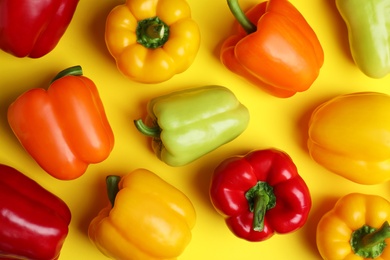 Photo of Flat lay composition with ripe bell peppers on yellow background
