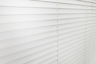 Photo of Closeup view of horizontal blinds on window indoors