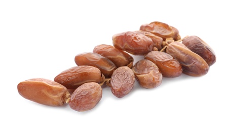 Photo of Sweet dates on branch against white background. Dried fruit as healthy snack