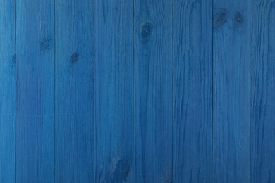 Photo of Texture of blue wooden board on black background, top view