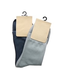 Photo of New pairs of cotton socks on white background, top view