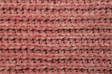 Beautiful pink knitted fabric as background, top view