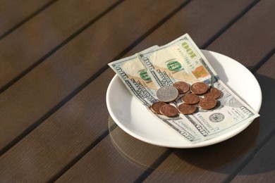 Photo of Saucer with payment for order on table, space for text. Leave tip