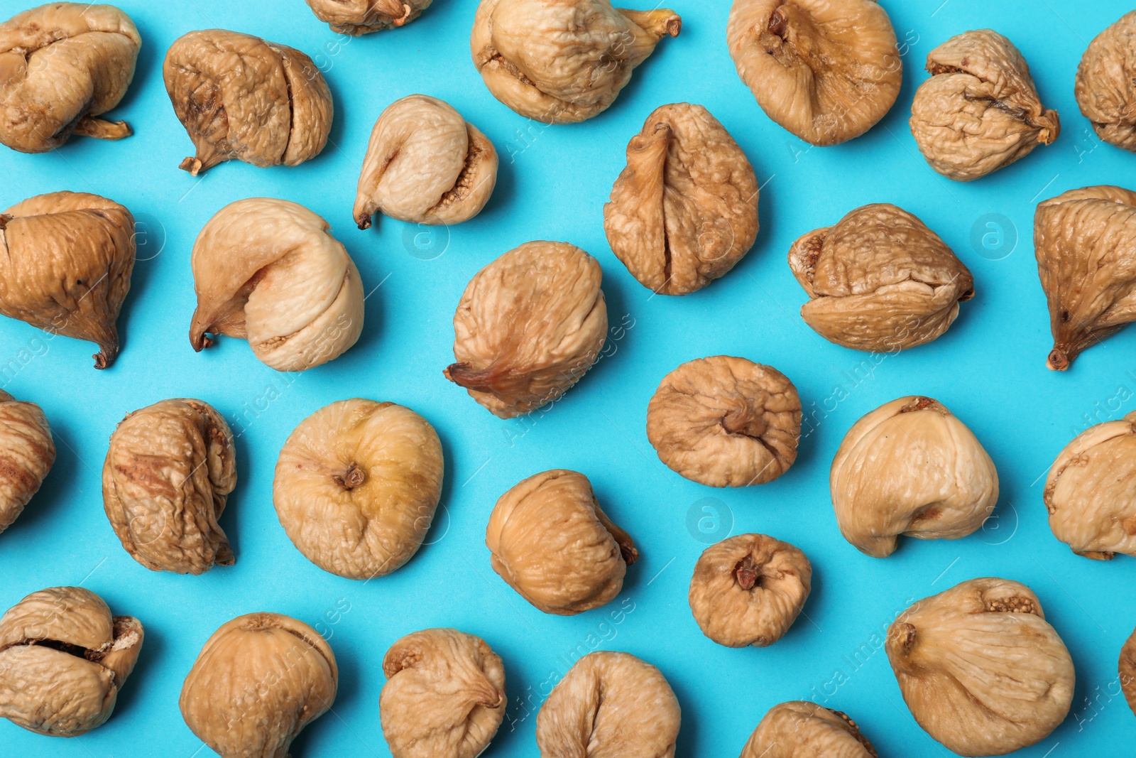 Photo of Flat lay composition with dried figs on  color background. Healthy fruit