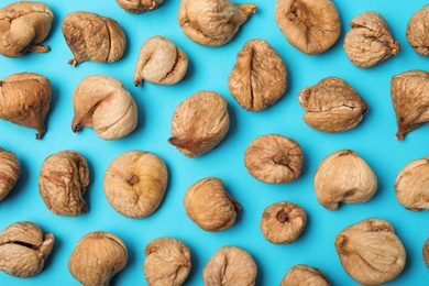 Photo of Flat lay composition with dried figs on  color background. Healthy fruit