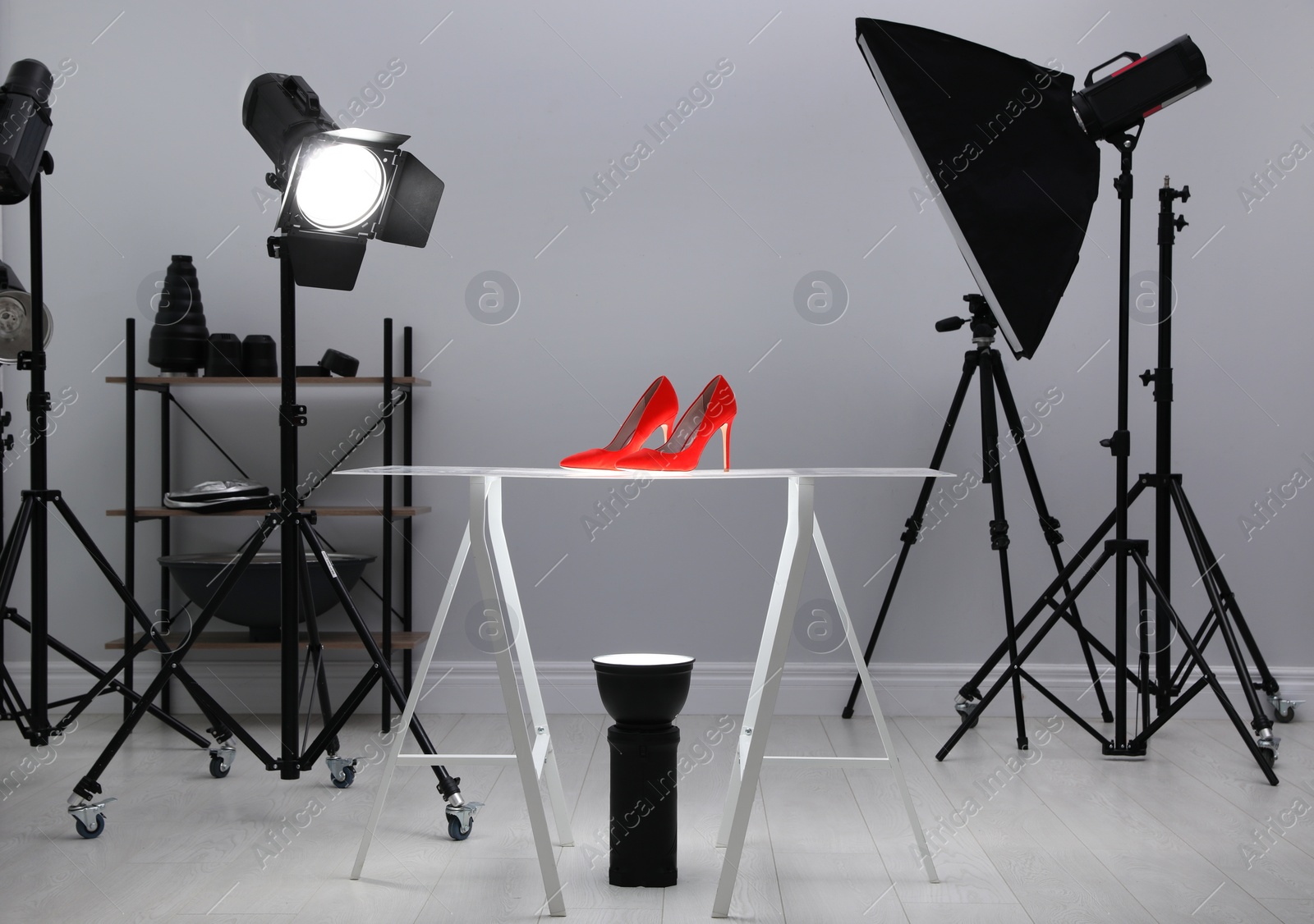 Photo of Professional photography equipment prepared for shooting stylish shoes in studio