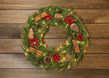 Photo of Beautiful Christmas wreath on wooden background, top view