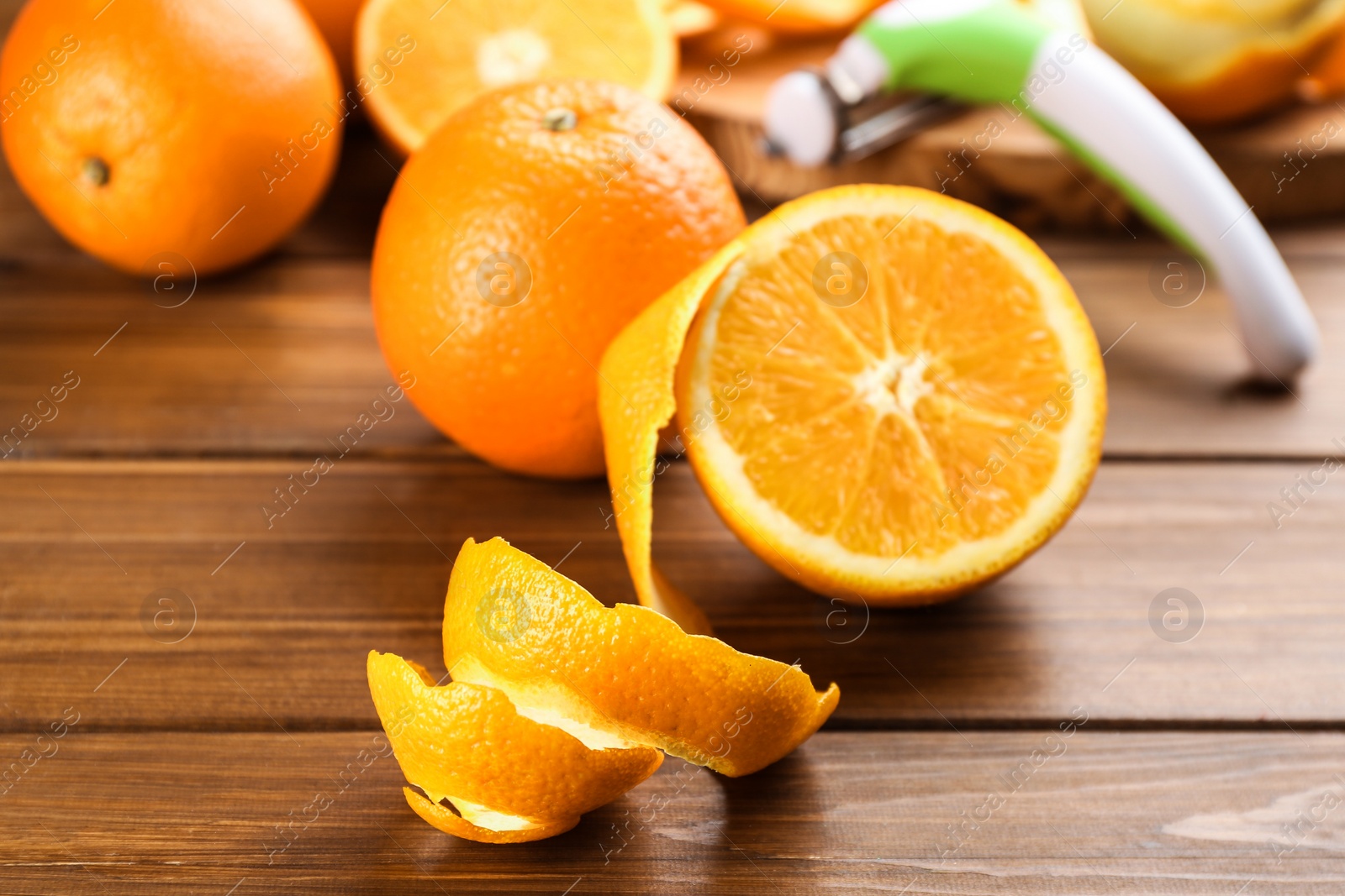 Photo of Orange fruits with peel on wooden table