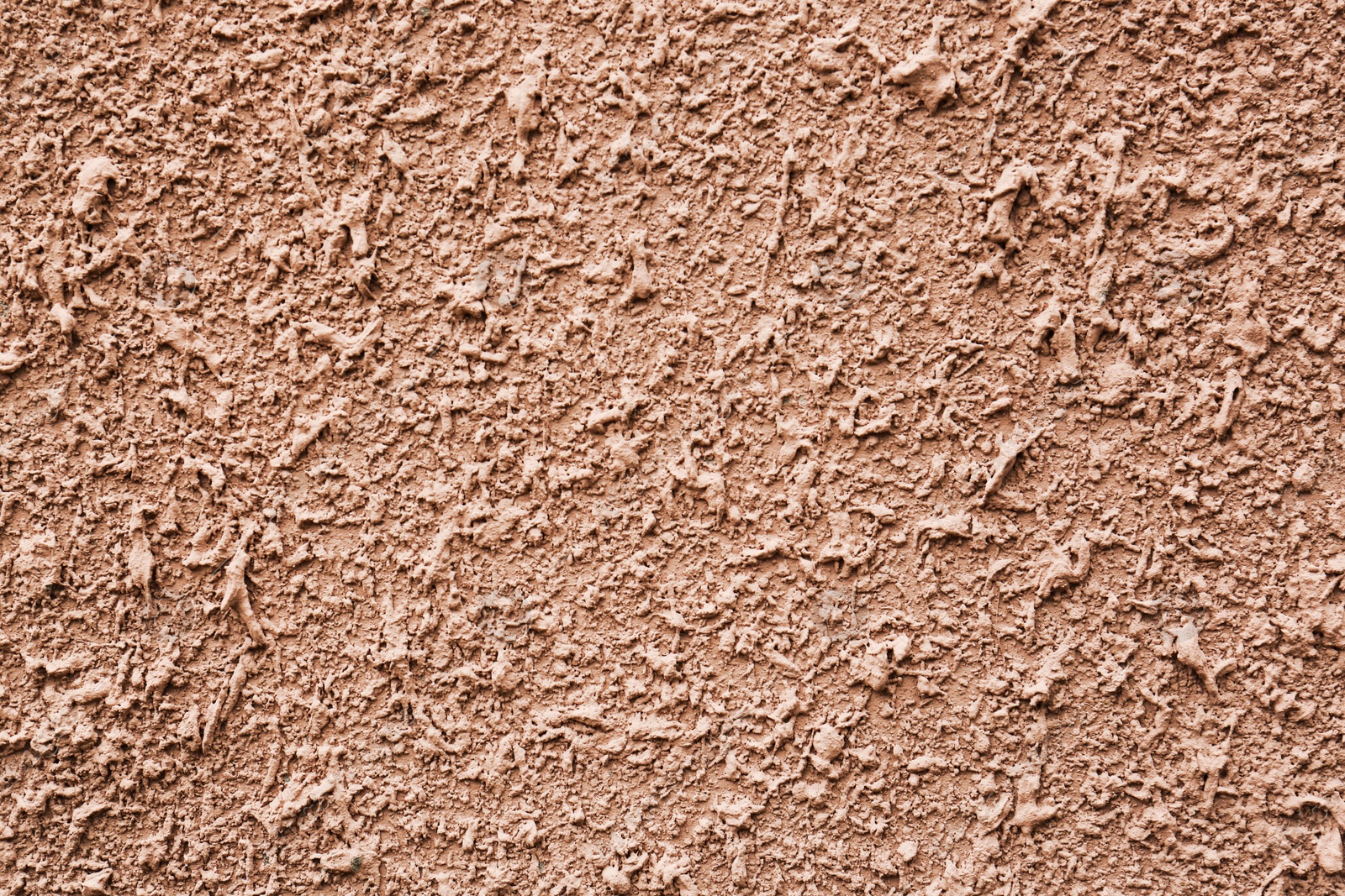 Photo of Texture of dark beige plaster wall as background, closeup