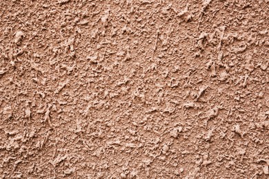 Texture of dark beige plaster wall as background, closeup