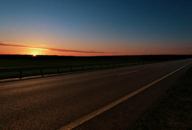 Image of Road trip. Beautiful view of asphalt highway at sunset