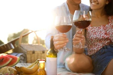 Happy couple having picnic outdoors on sunny day, closeup