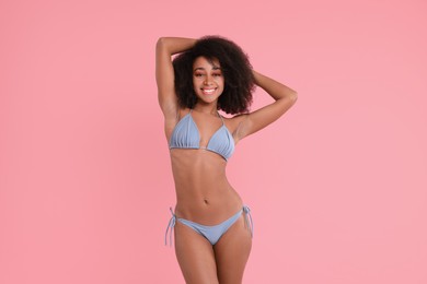 Beautiful woman in stylish bikini on pink background