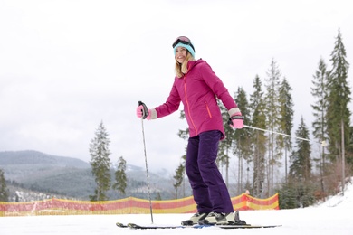 Photo of Female skier on slope at resort. Winter vacation