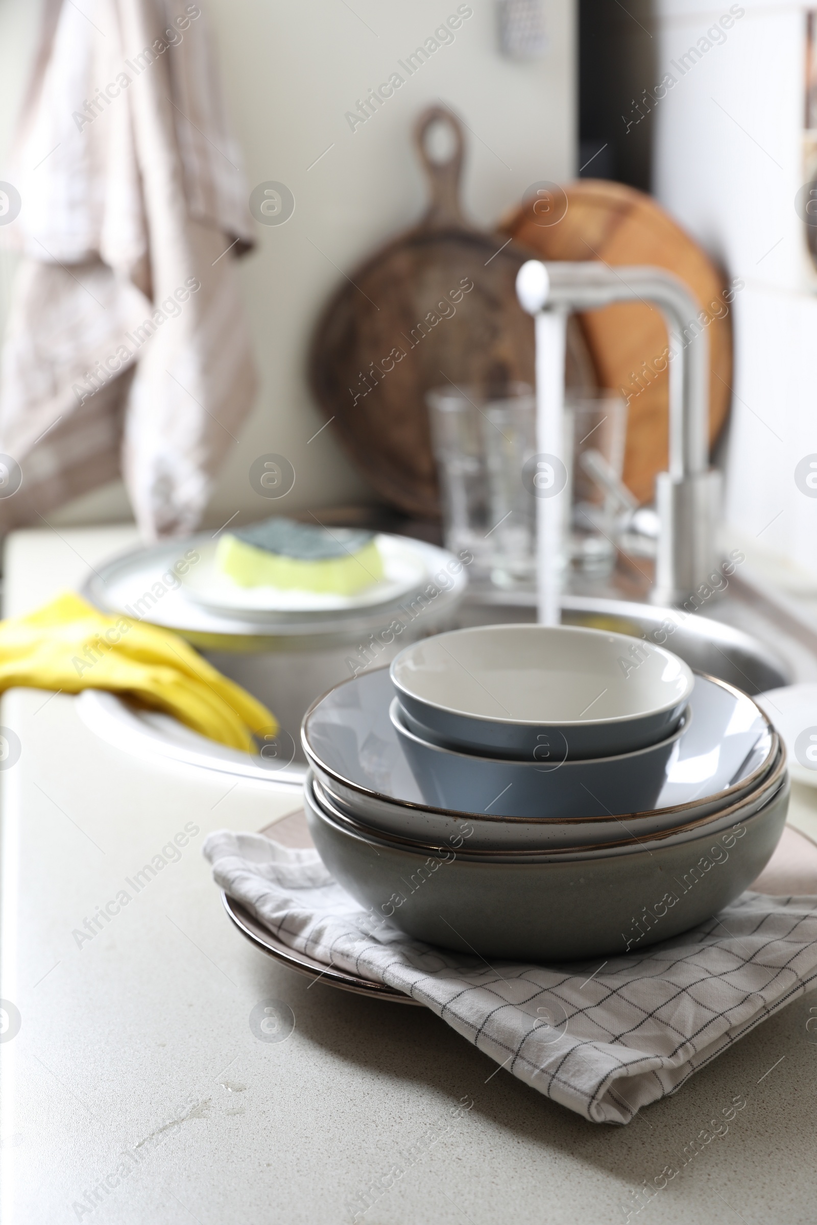 Photo of Clean bowls near kitchen sink. Washing dishes