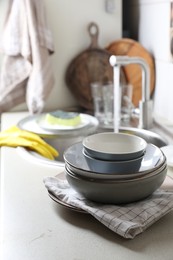 Photo of Clean bowls near kitchen sink. Washing dishes