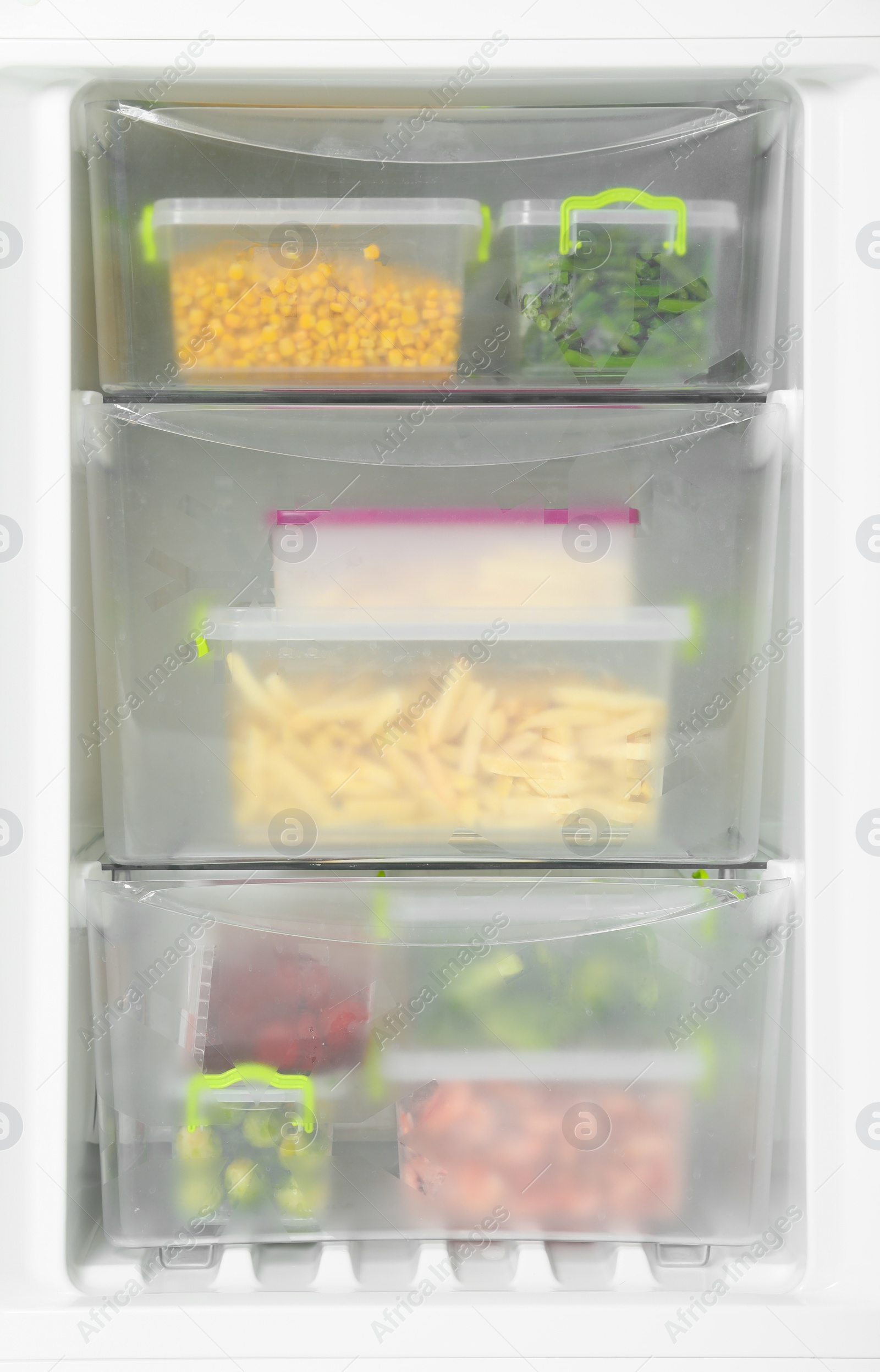 Photo of Containers with frozen vegetables in refrigerator, closeup