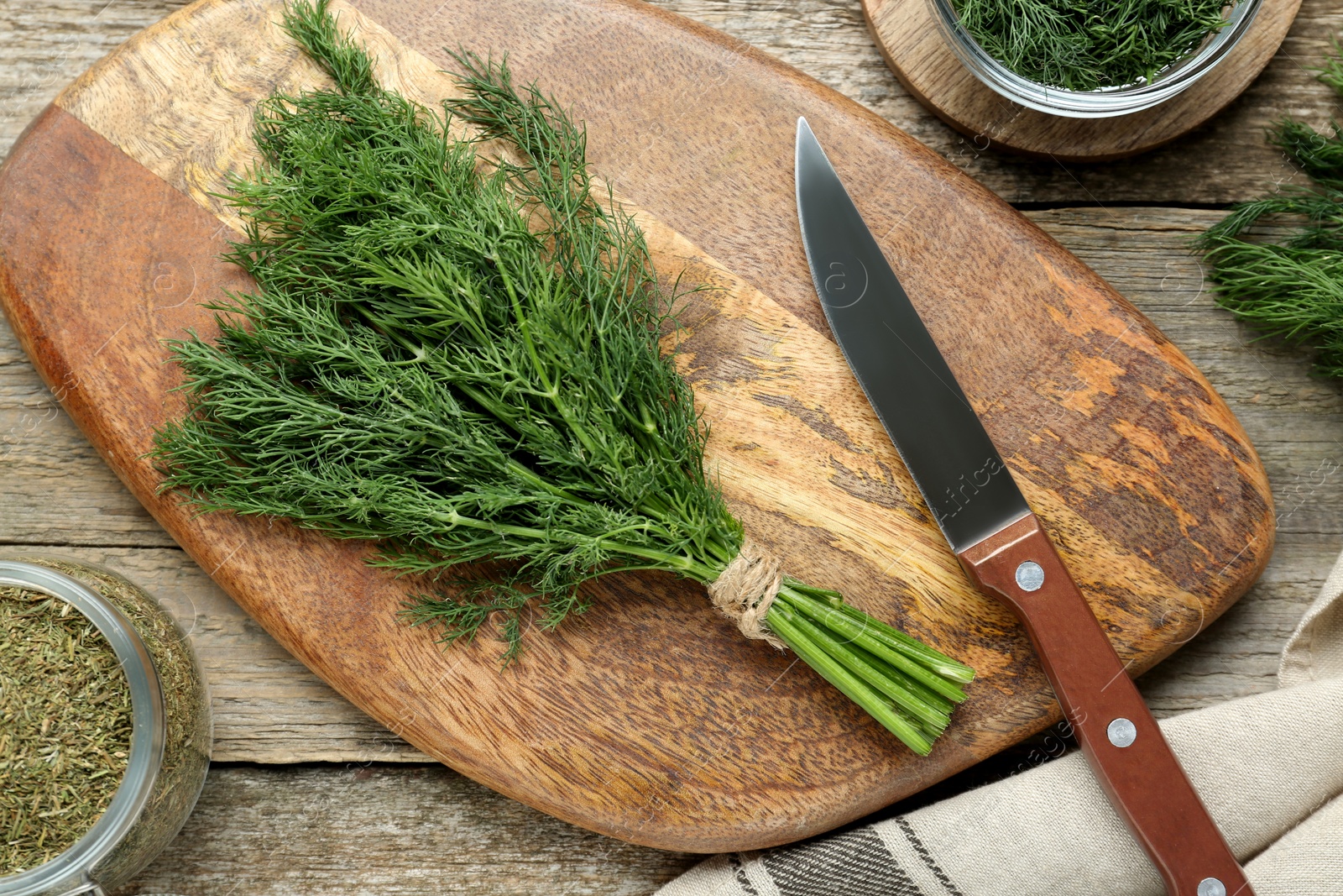Photo of Fresh dill preparing for drying on wooden table, flat lay