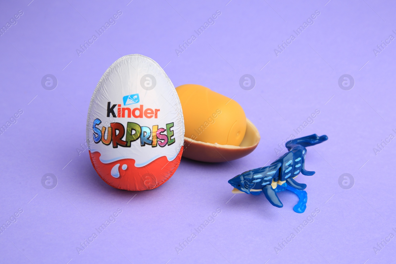 Photo of Sveti Vlas, Bulgaria - June 30, 2023: Kinder Surprise Eggs, plastic capsule and toy on violet background