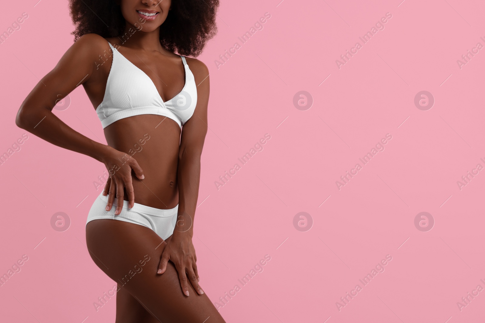 Photo of Woman in stylish bikini on pink background, closeup. Space for text