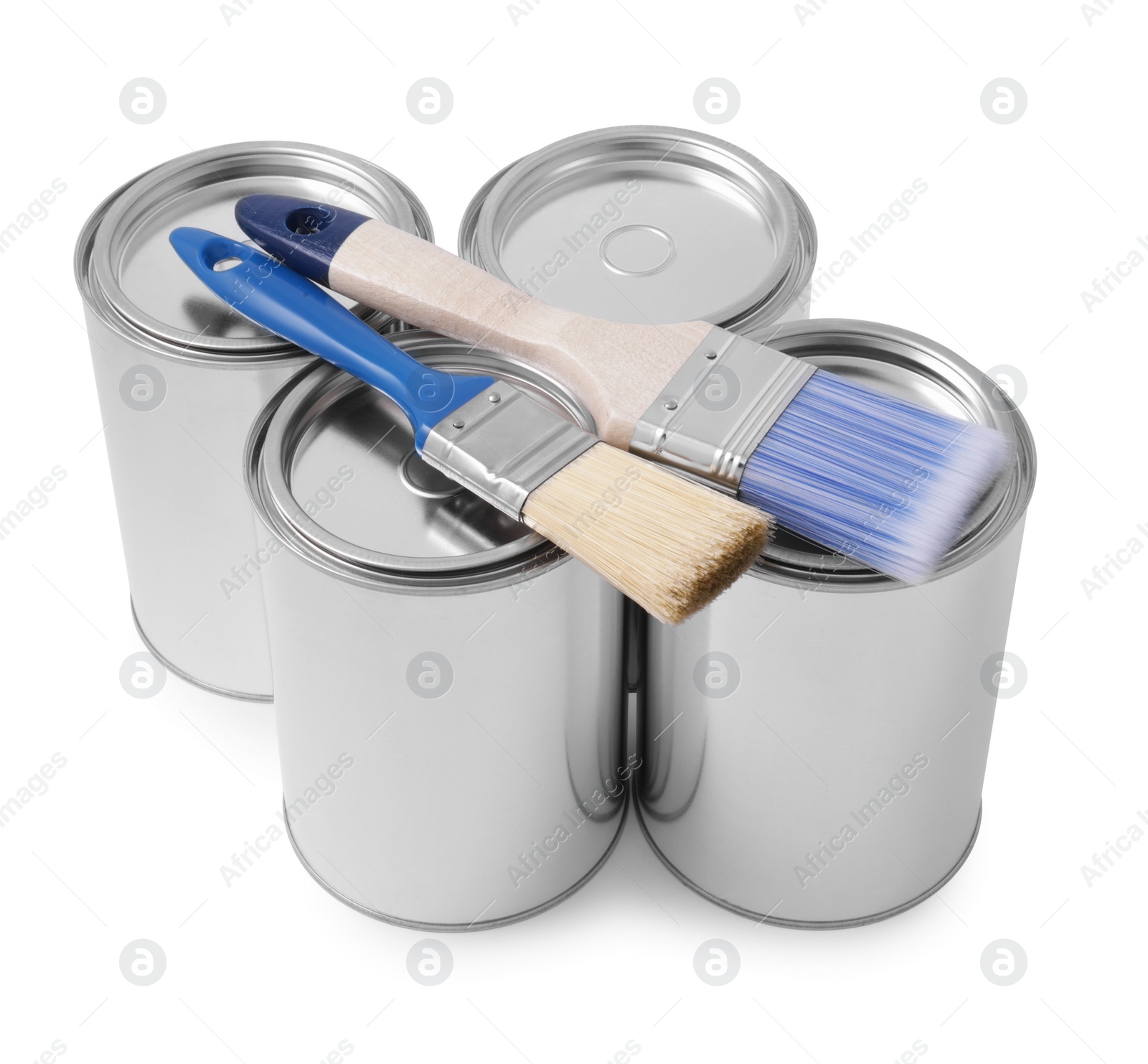 Photo of Cans of paints and brushes on white background