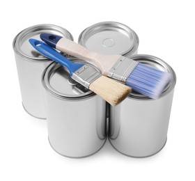 Photo of Cans of paints and brushes on white background