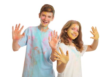 Happy teens covered with colorful powder dyes on white background. Holi festival celebration