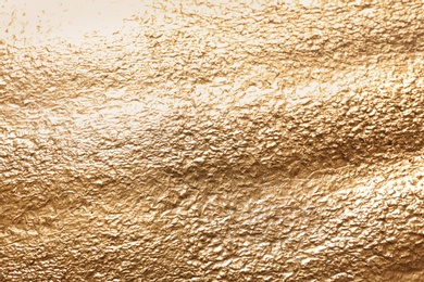 Photo of Rough golden surface as background, top view