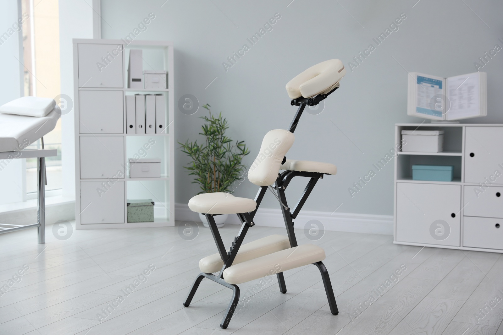 Photo of Modern massage chair in clinic. Medical equipment